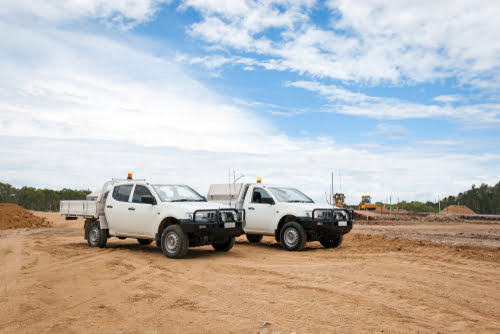 2 Utes in a dirt clearing - NQ Car & Truck Rentals